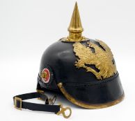 A Prussian Pickelhaube, leather bodied helmet with brass spike and plate marked Mit Gott Fur Konig