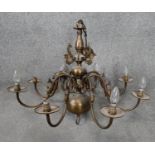 A Dutch style bronze effect brass eight branch chandelier with dolphin motifs. D.84cm