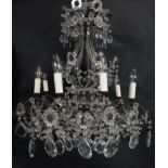 A vintage metal framed eight branch ceiling chandelier with cut crystal drops. Dia.65cm