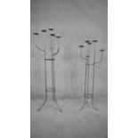 Two wrought iron six branch floor standing candelabras with abstract branched design. H.110cm