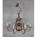 A Baroque style bronze effect brass eight branch chandelier with dolphin motifs. D.70cm