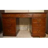 An early 20th century Georgian style mahogany three part pedestal desk.