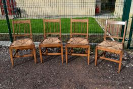 A set of four 19th century elm and inlaid dining chairs. (rush seats in need of repair)
