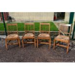 A set of four 19th century elm and inlaid dining chairs. (rush seats in need of repair)