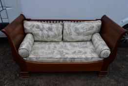 An Empire style two seaster mahogany sofa.
