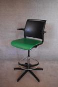 A contemporary swivel/rise and fall action office chair