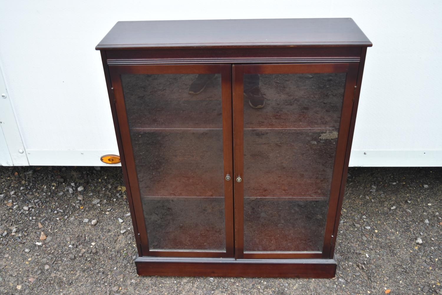 A mahogany glazed floor standing bookcase.