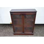 A mahogany glazed floor standing bookcase.