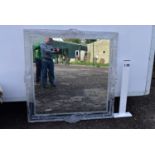 A large moulded clear perspex wall mirror.