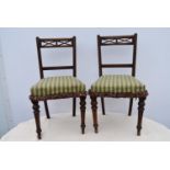 A pair of late 19th century oak dining chairs.