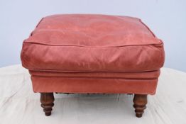 A leather upholstered footstool.