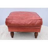 A leather upholstered footstool.