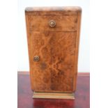 An Art Deco burr walnut bedside cabinet.