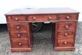 A Victorian style stained pine pedestal desk.