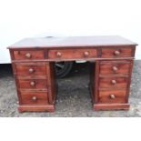 A Victorian style stained pine pedestal desk.