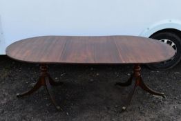 A Georgian style mahogany dining table with extra leaf.