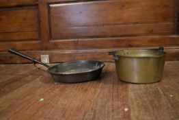 A 19th century brass preserve pan and a similar frying pan.