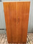 A 20th Century teak double wardrobe