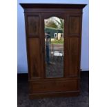 An Edwardian mahogany and satinwood inlaid wardrobe.