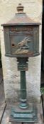 A vintage style cast iron post or letter box on pedestal base with relief jockey design. H.120xW.