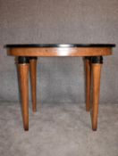 A Continental Art Deco bird's eye walnut centre table with oval ebonised top on circular tapering