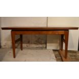 A mid century teak coffee table with rising action and draw leaves to convert to a dining table.