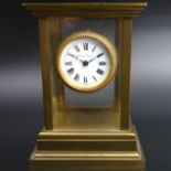 Mathew Norman brass and glass mantle clock, with a Swiss movement. 15 cm high x 11 cm wide. UK