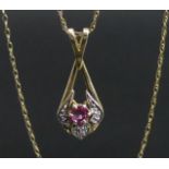 9 carat gold ruby and diamond pendant and 40 cm chain. 1.7 grams. Pendant 25 mm x 10 mm. UK