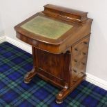 A Victorian walnut Davenport the fitted interior over 4 drawers and four dummy ones. Circa 1880.