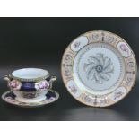 A finely painted English porcelain sauce tureen and stand along with a cabinet plate, dating from