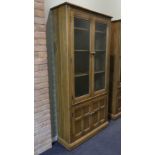 Ercol Grasmere elm glazed bookcase over a two door cupboard. Ercol seal to the inside of the door.