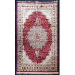 Red ground, full pile, Kashmir rug, with a central floral medallion deign. 240 cm x 160 cm.