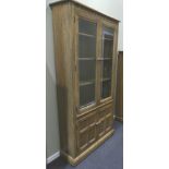 Ercol Grasmere elm glazed bookcase over a two door cupboard. Ercol seal to the inside of the door.