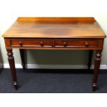 Victorian two drawer mahogany writing table on fluted tapering legs. 52 cm deep x 107 cm wide.
