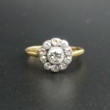 18 carat gold and diamond cluster, the clean bright centre stone is approx. 4.5 mm in diameter. Size