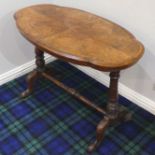 Victorian walnut inlaid and cross banded table, on a turned and carved base. 58 cm x 99 cm.