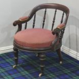 Victorian mahogany tub chair on turned legs terminating in white china castors. 64 cm wide.