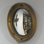 Regency style old gilt framed convex wall mirror. 42 cm diameter. UK Postage £20.