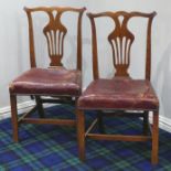 A pair of Georgian country dining chairs with leather over-stuffed seats. 51 cm wide. Collection