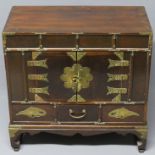 Old Chinese mahogany and pine brass embellished cupboard over three drawers. 60 x60 29 cm.