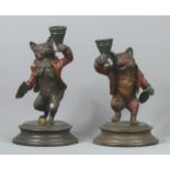 A bronze cold painted pair of fox figural candlesticks. 18 cm high. UK Postage £15.