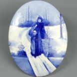 Royal Doulton blue and white pottery wall plaque, depicting a young lady coming home in the snow.