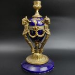 A decorative gilt bronze and pottery classical design candlestick. 27 cm high. UK Postage £20.