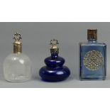 Three vintage white metal topped perfume bottle. Tallest 11 cm. UK Postage £15.