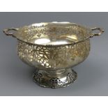 George V silver twin handled pierced pedestal bowl, Birmingham 1928, H Mathews. 20 cm wide x 11 cm