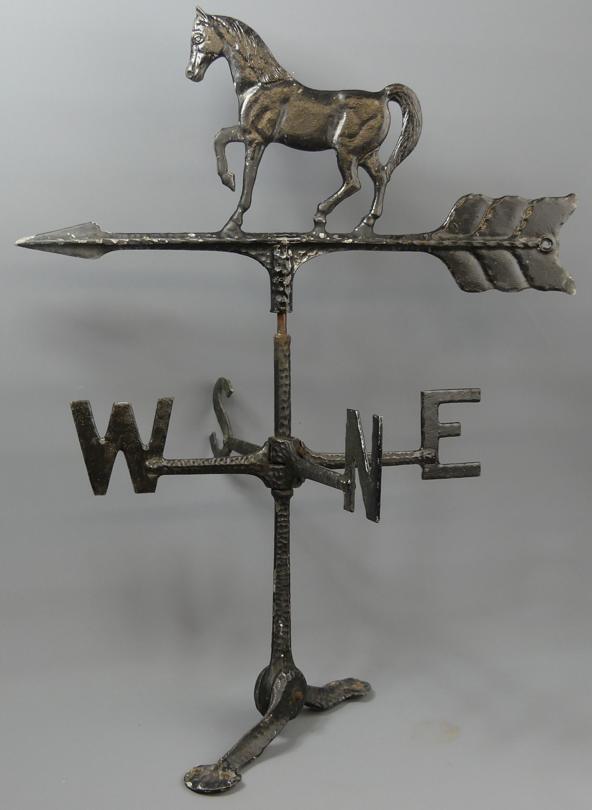 A cast painted black weather vane with horse a figure to the top. 61 cm high. UK Postage £20.