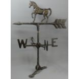 A cast painted black weather vane with horse a figure to the top. 61 cm high. UK Postage £20.