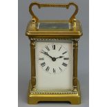 Victorian brass carriage clock with an enamel dial. 15 cm high. UK Postage £15.