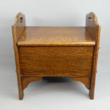 1930's oak stool the hinged lid opening to reveal a sewing box and contents. 45 cm high x 42.5 cm