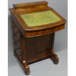 A Victorian walnut Davenport the fitted interior over 4 drawers and four dummy ones. Circa 1880.